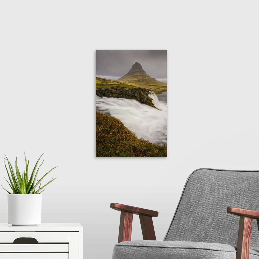 A modern room featuring Kirkjufellsfoss in autumn with hiker to show scale, Iceland, Polar Regions