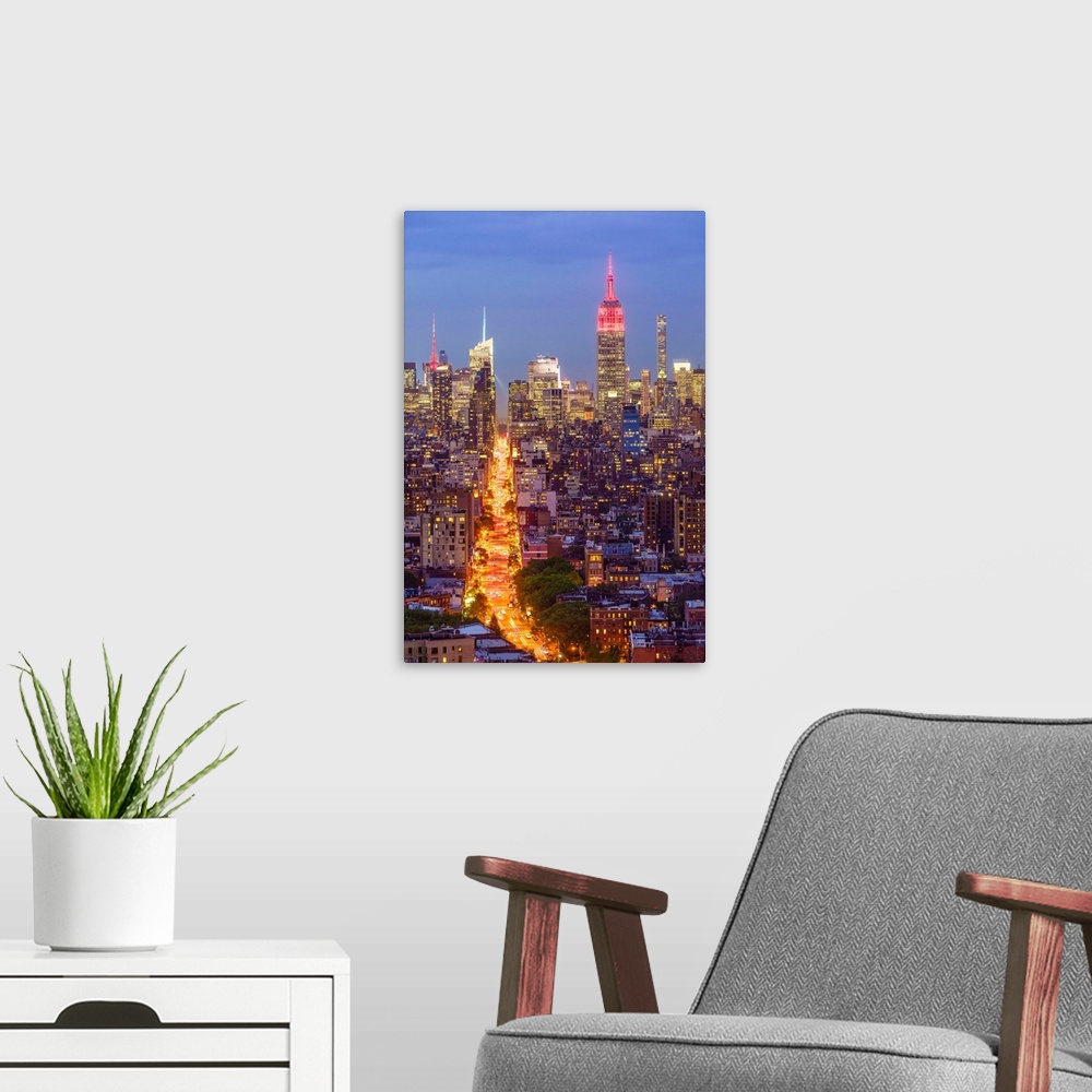 A modern room featuring Manhattan skyline at dusk with the Empire State Building, New York City