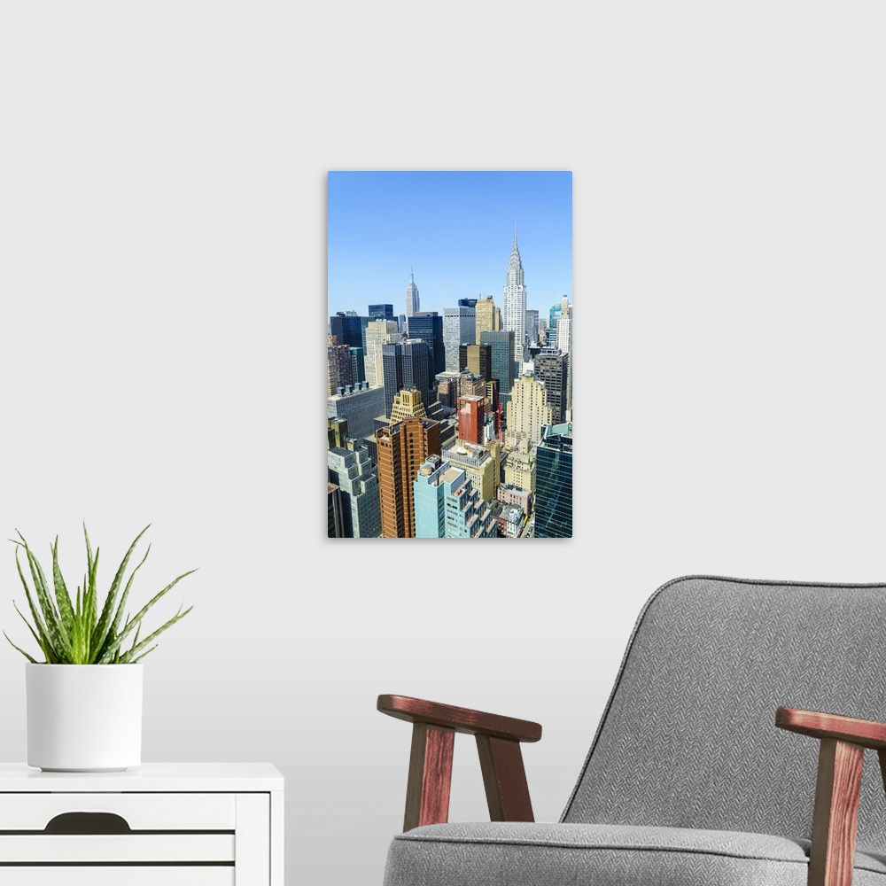 A modern room featuring Manhattan skyline, Empire State Building and Chrysler Building, New York City, United States of A...