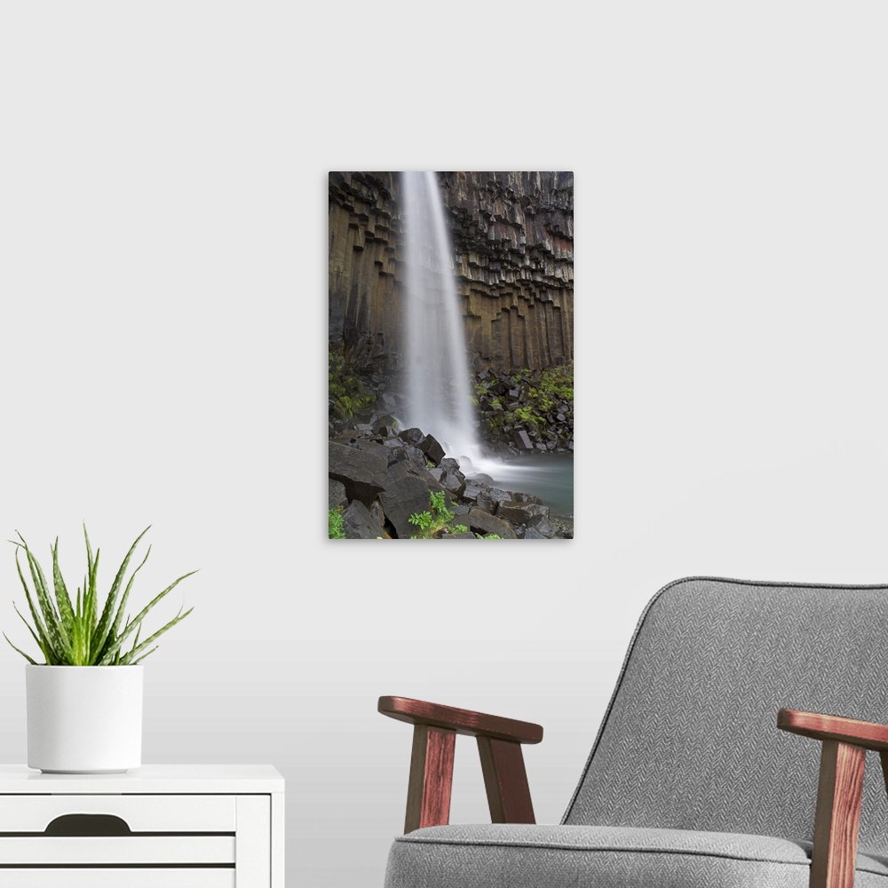 A modern room featuring Svartifoss waterfall with basalt columns in Skaftafell National Park, Iceland