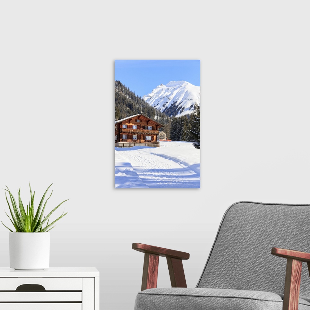 A modern room featuring Typical wooden hut framed by woods and snowy peaks, Langwies, district of Plessur, Canton of Grau...