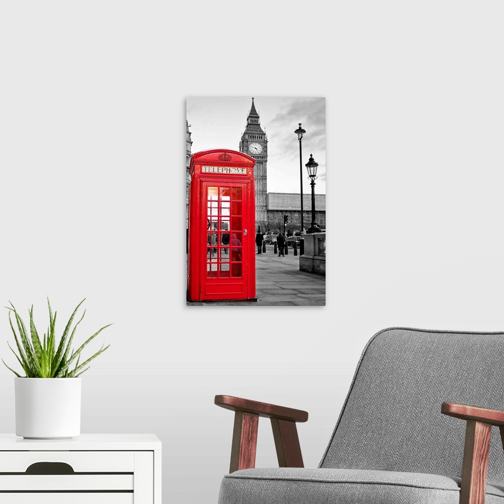A modern room featuring A  traditional red phone booth in London with the Big Ben in a black and white background