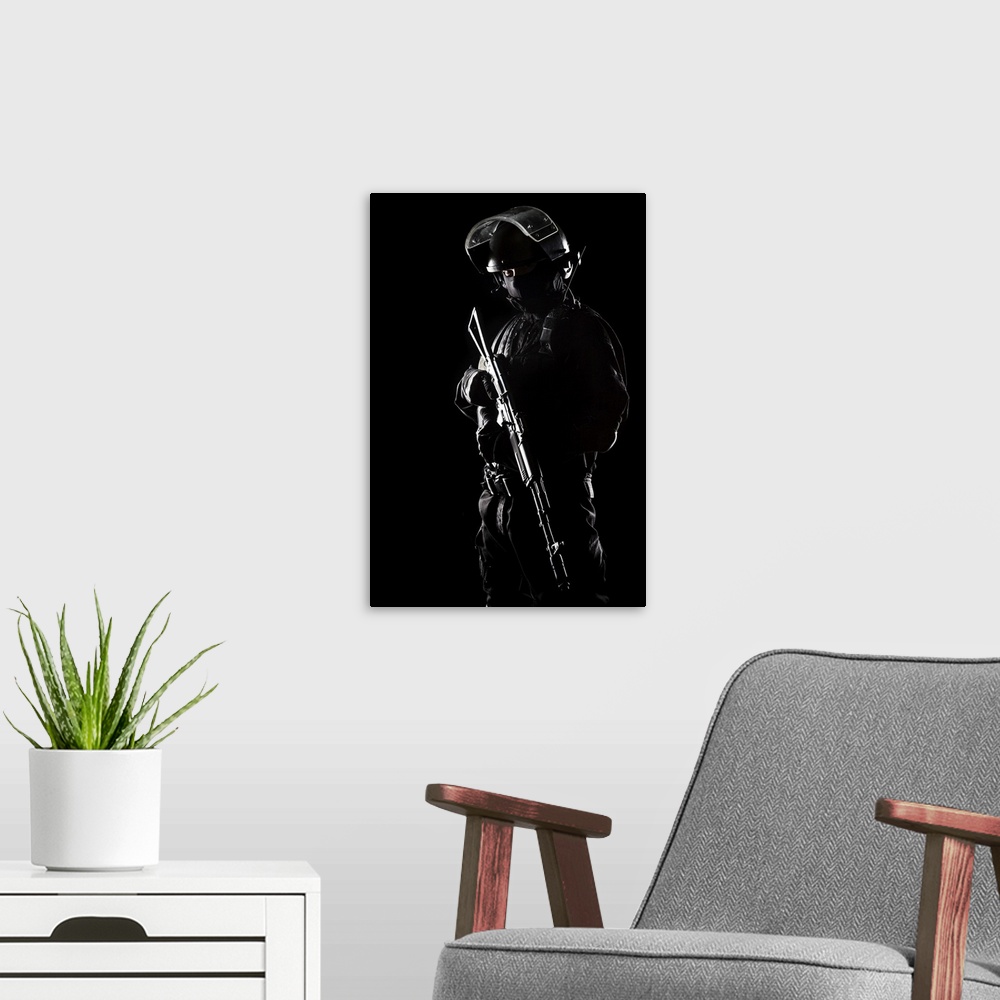 A modern room featuring Contour shot of spec ops soldier on black background.