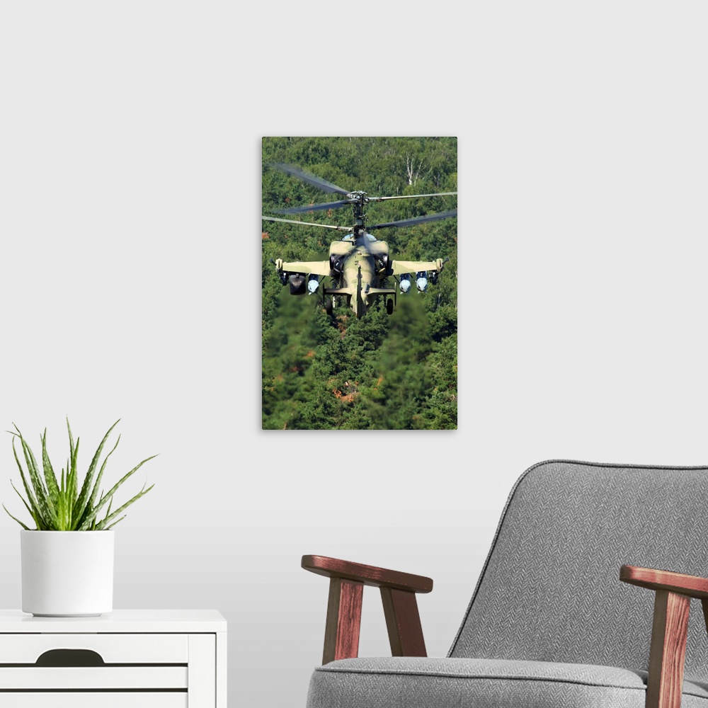 A modern room featuring Ka-52 Alligator attack helicopter of the Russian Air Force flying over treetops.