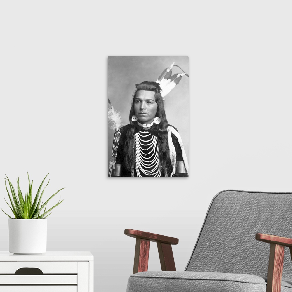 A modern room featuring Native American portrait of Joseph Cregg, a man from the Plateau region, wearing necklaces.