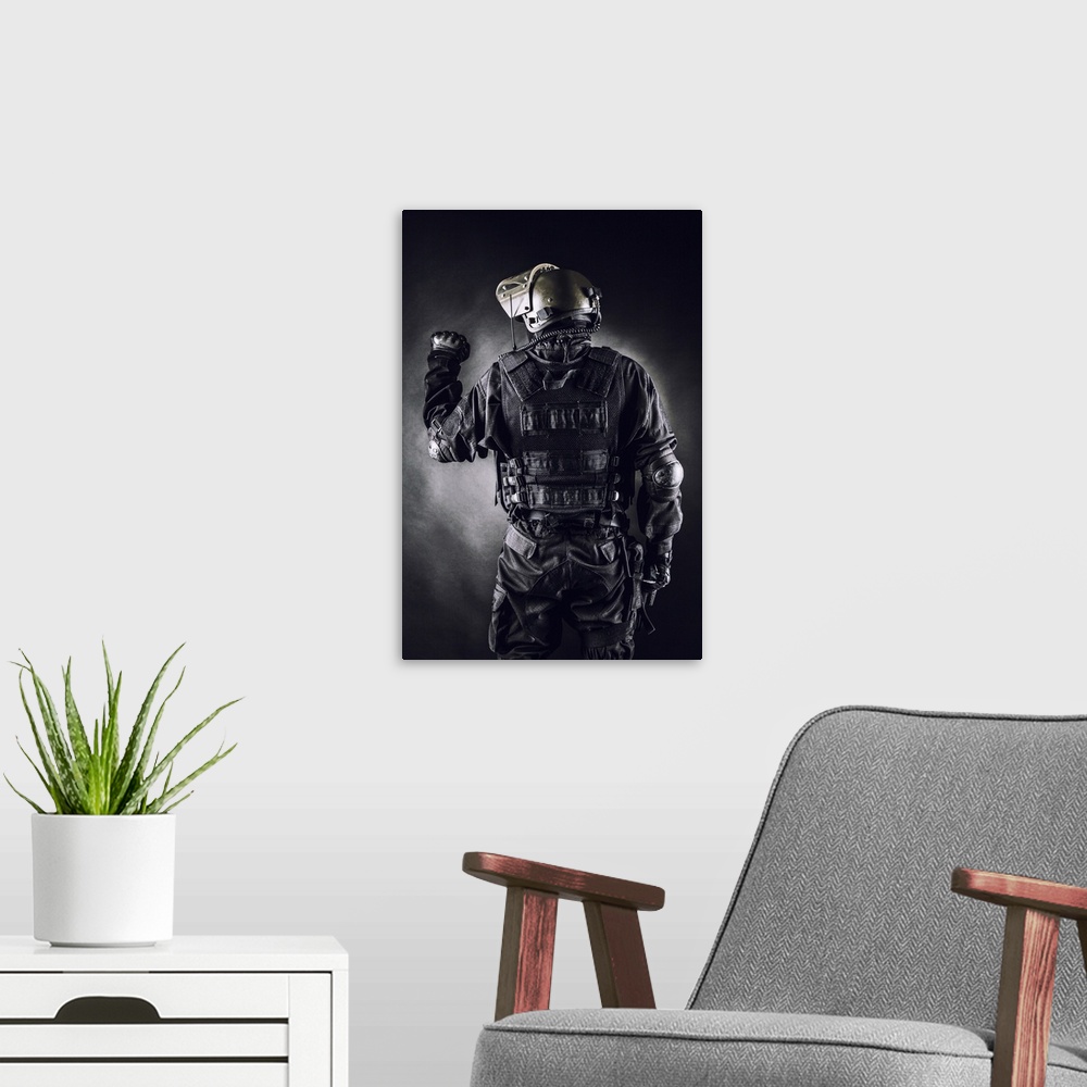 A modern room featuring Spec ops soldier on black background shot from behind.