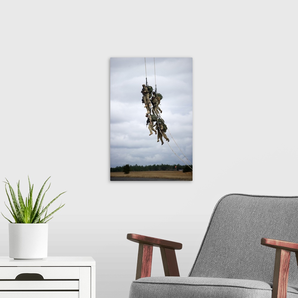 A modern room featuring U.S. Soldiers are lifted off the ground by a CH-47 Chinook helicopter.