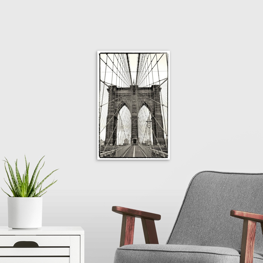 A modern room featuring Black and white photograph of a dramatic view of the Brooklyn Bridge.
