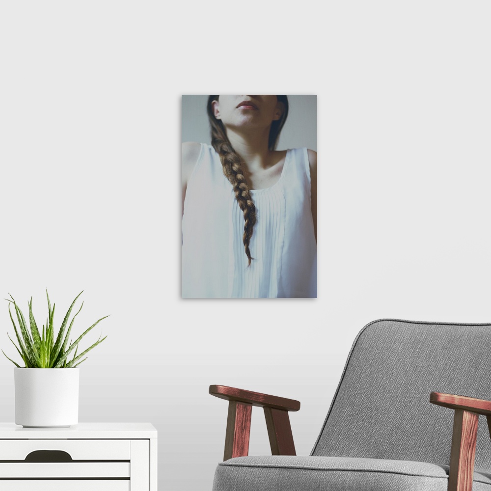 A modern room featuring faceless portrait of a girl with pale light and braided hair