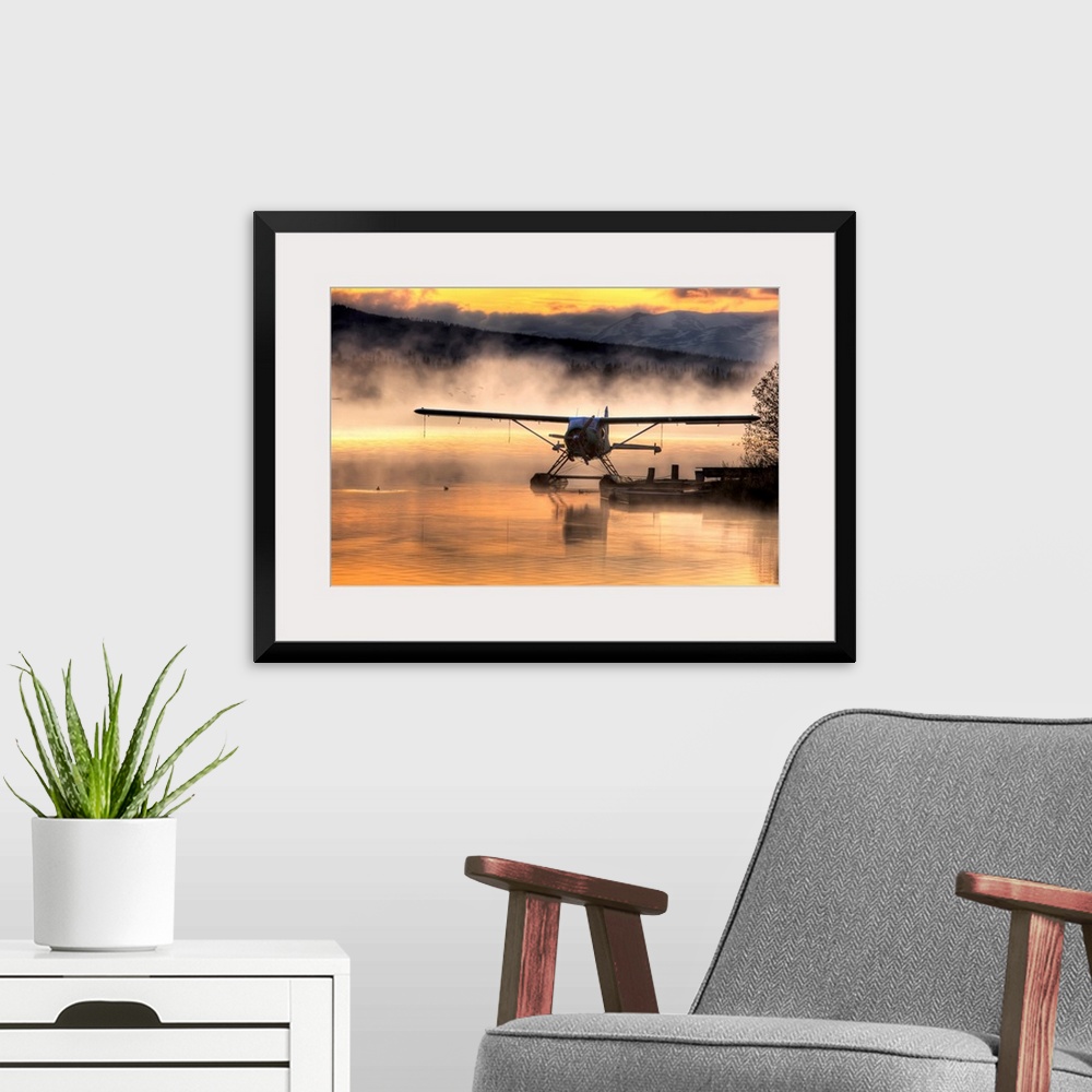 A modern room featuring Giant photograph displays a seaplane sitting next to a dock as a soft fog rolls over the water.  ...