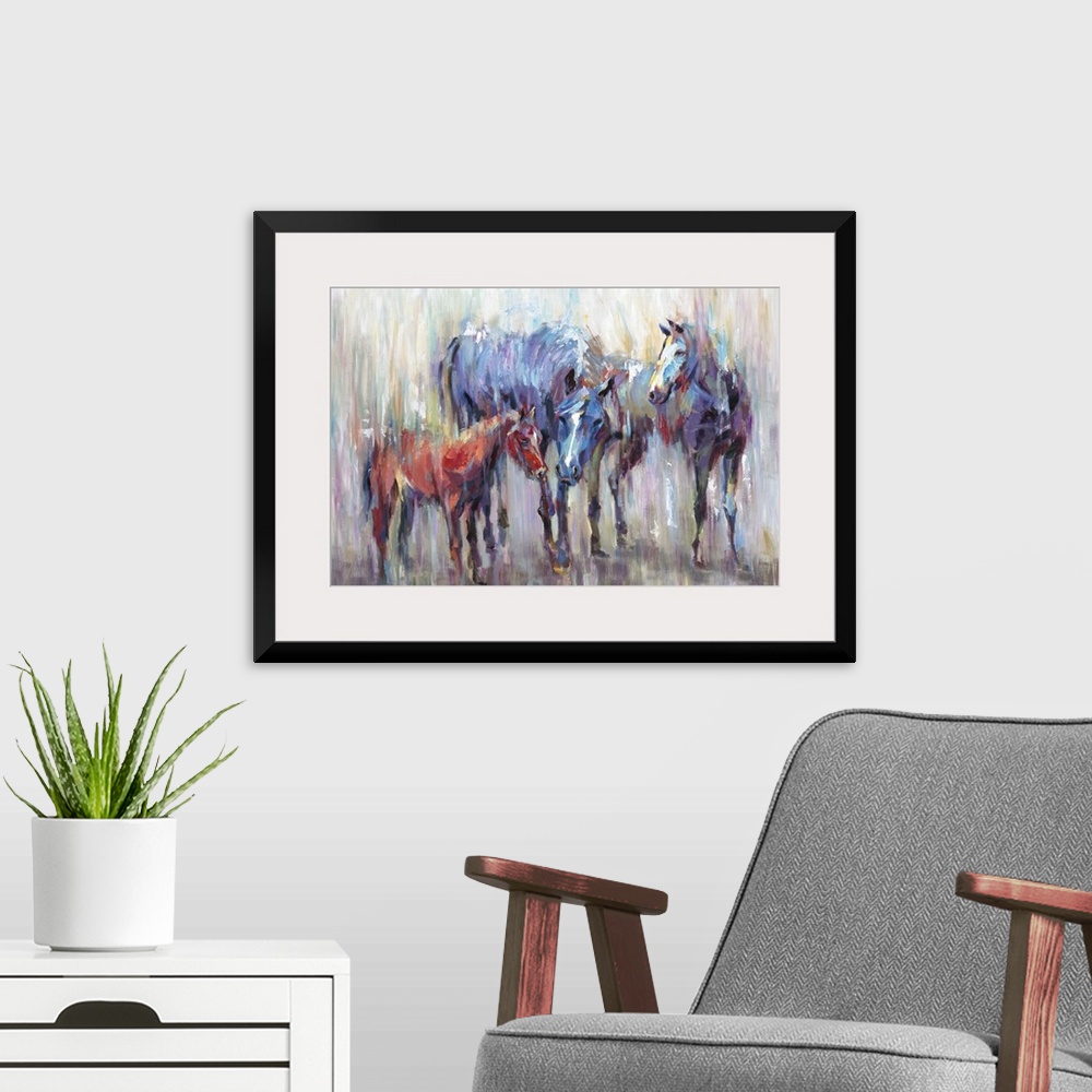 A modern room featuring Home decor artwork of two adult multi-colored horses with a small brown one.