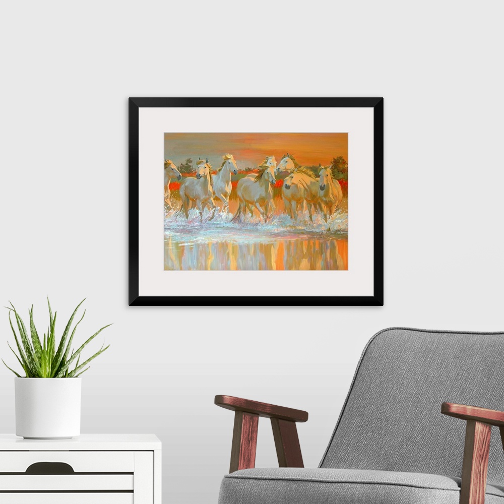 A modern room featuring Landscape canvas wall art of wild, white horses galloping through water at sunset.