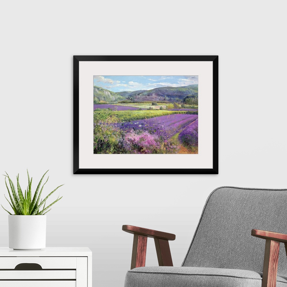 A modern room featuring Big painting of fields of lavender with rolling hills in the background. Cooling tones are featur...