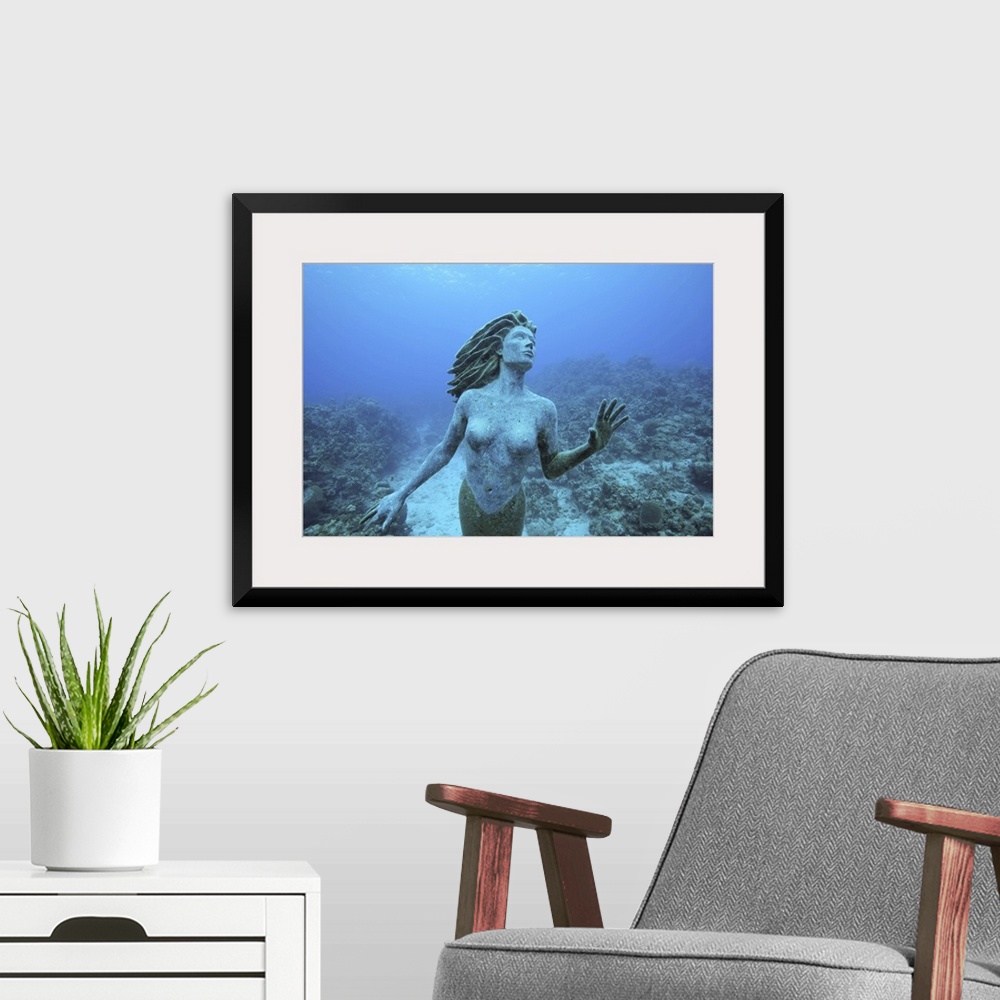 A modern room featuring Cayman Islands, Grand Cayman Island, Underwater view mermaid sculpture in shallow coral reefs in ...