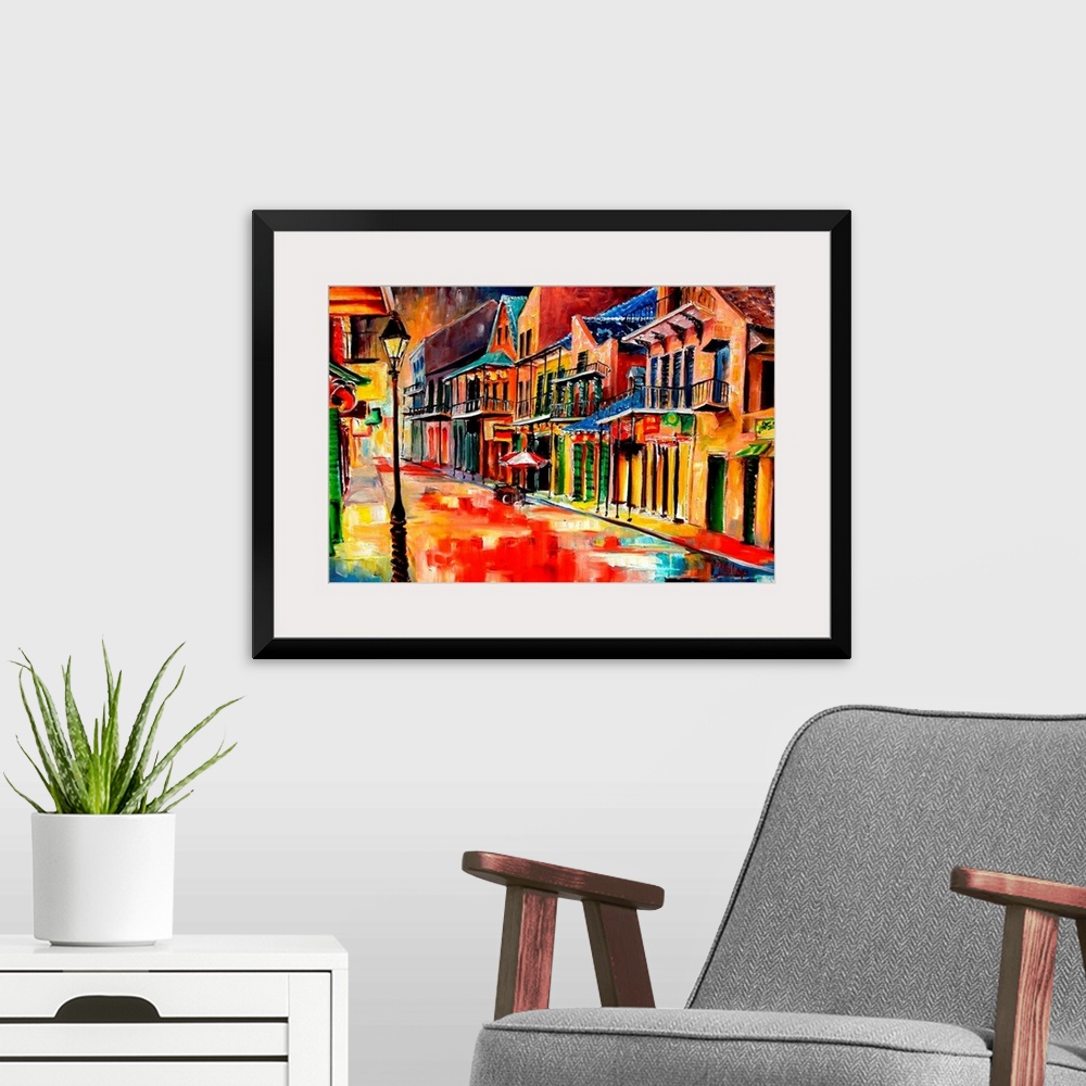 A modern room featuring Huge contemporary art shows the vibrantly colored buildings lit up on a quiet street in Louisiana...