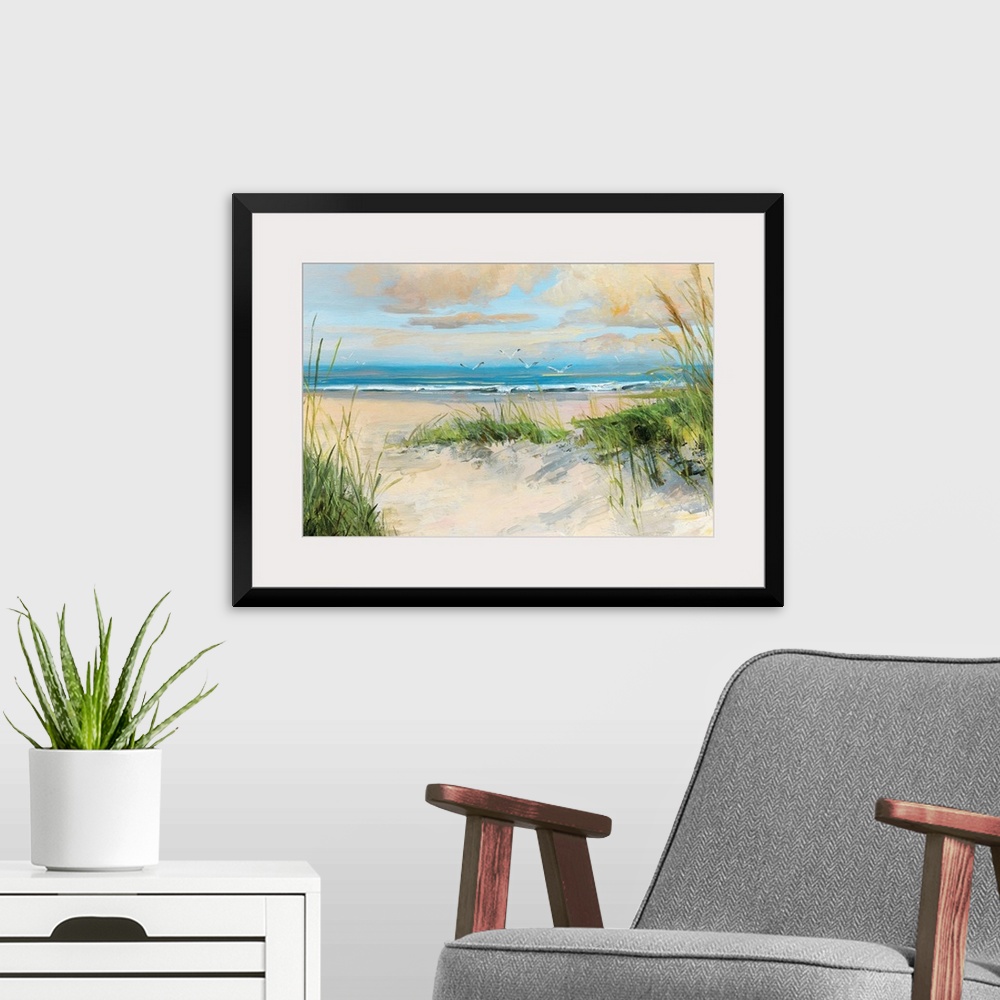 A modern room featuring Contemporary painting of a sandy beach with birds flying towards the ocean.