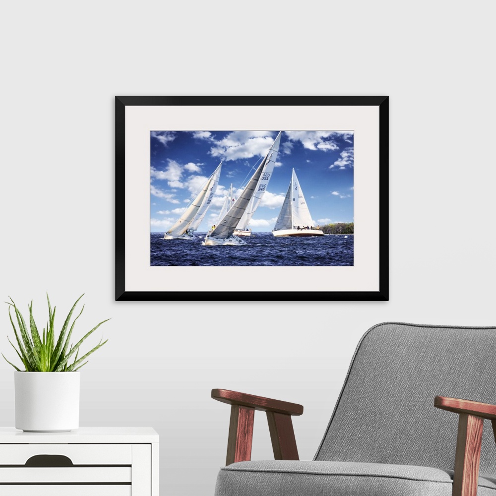 A modern room featuring Three white sailboats on the water under a cloudy blue sky.