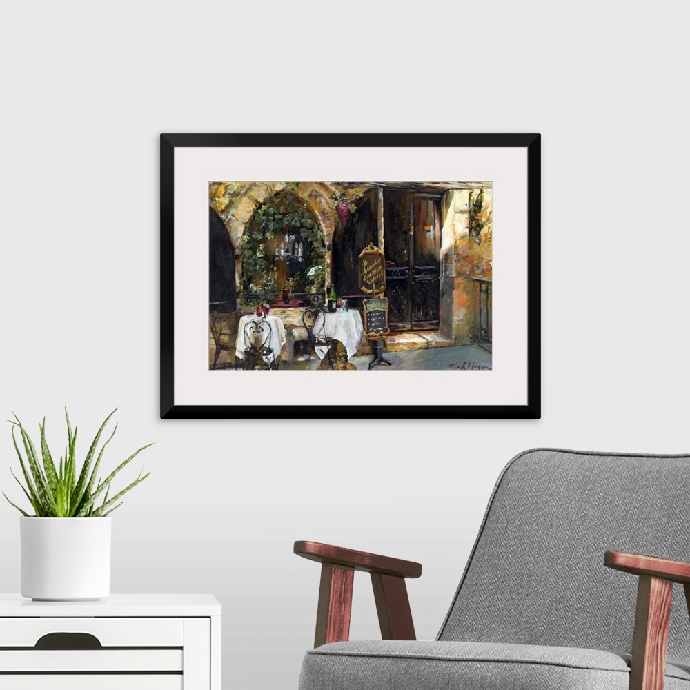 A modern room featuring An impressionistic painting of an outdoor cafo in a rustic European city.