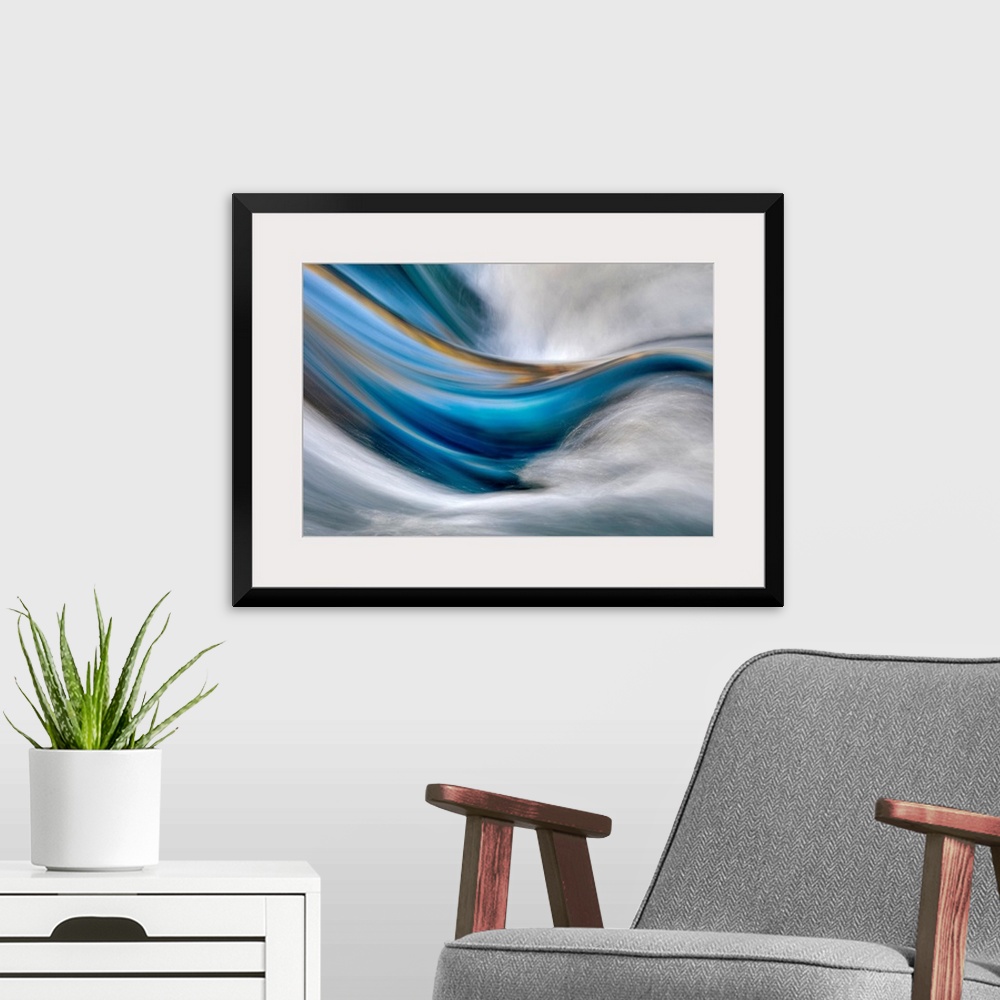 A modern room featuring Abstract painting in which cool and warm tones flow from left to right while white rushes from th...