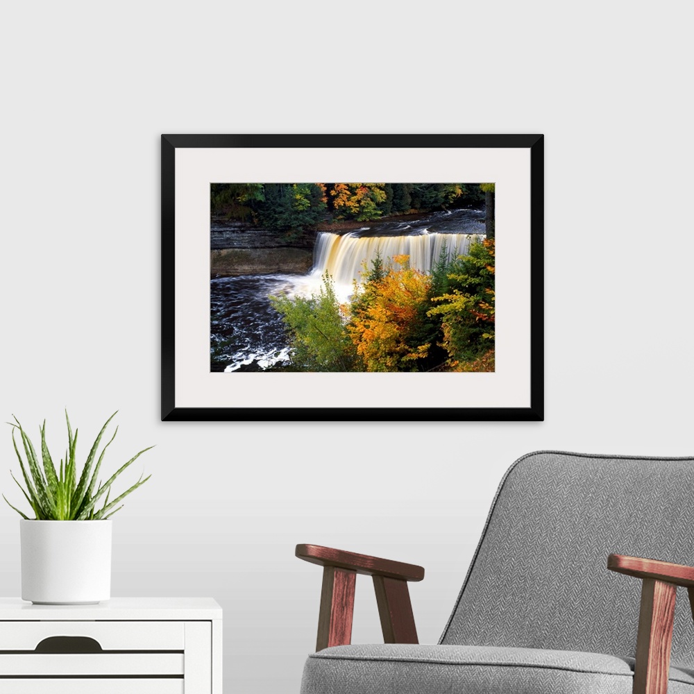 A modern room featuring Giant, horizontal photograph of Tahquamenon Falls surrounded by colorful fall foliage in Michigan.