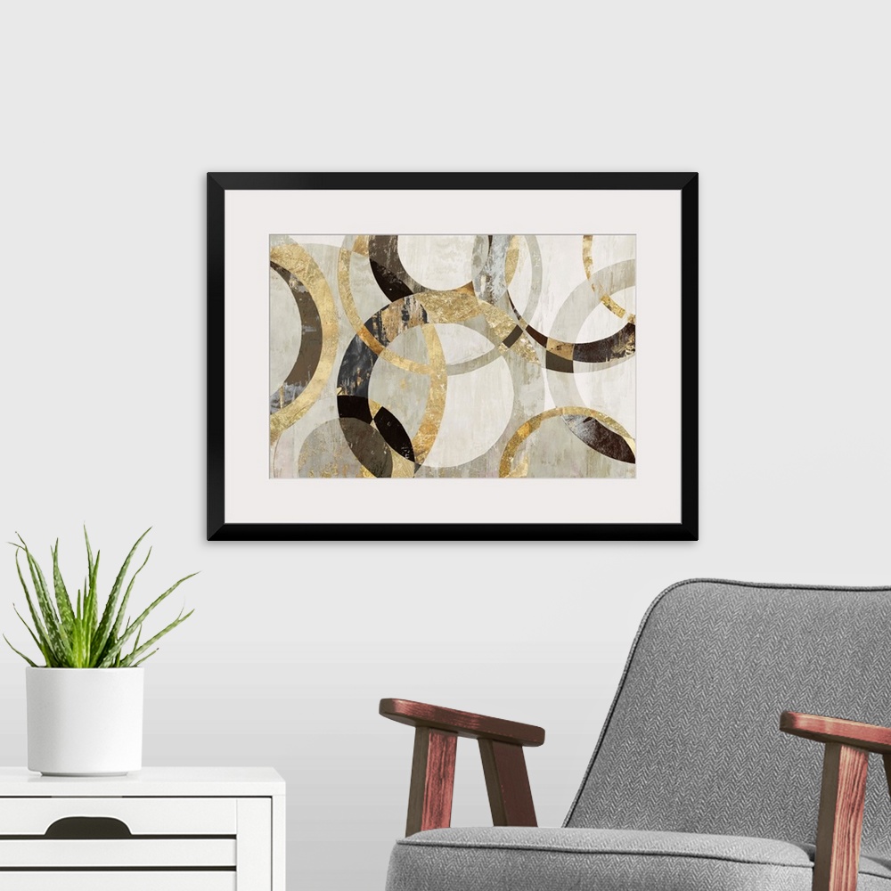 A modern room featuring Geometric abstract artwork with circular rings in shades of brown, gold, and gray.