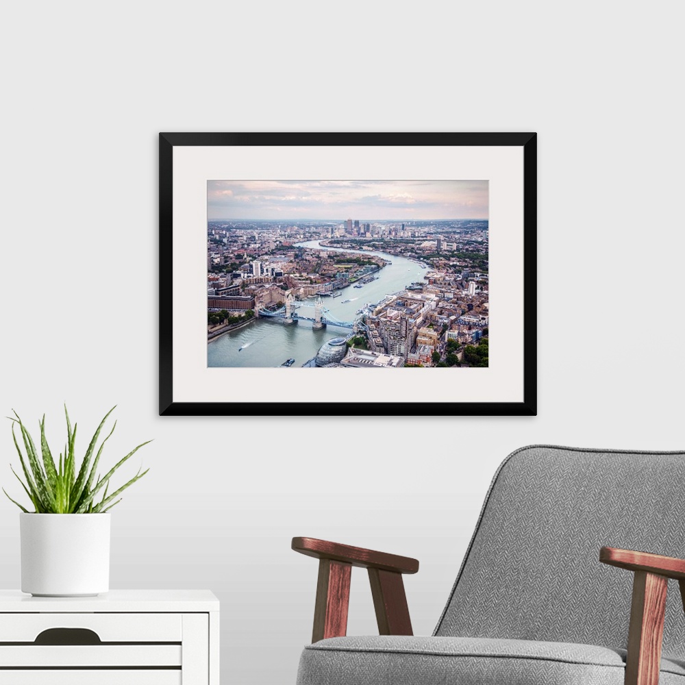 A modern room featuring Aerial view of River Thames and Tower Bridge in London, England.