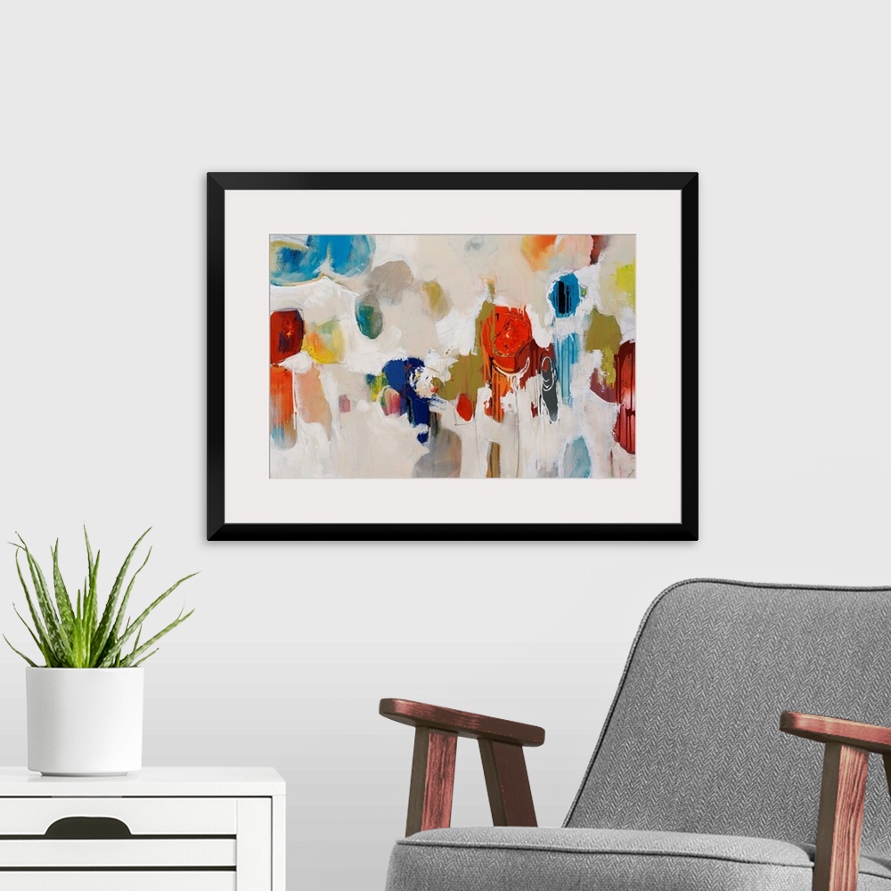 A modern room featuring Big, colorful swirls of paint on this horizontal photograph of an abstract painting.