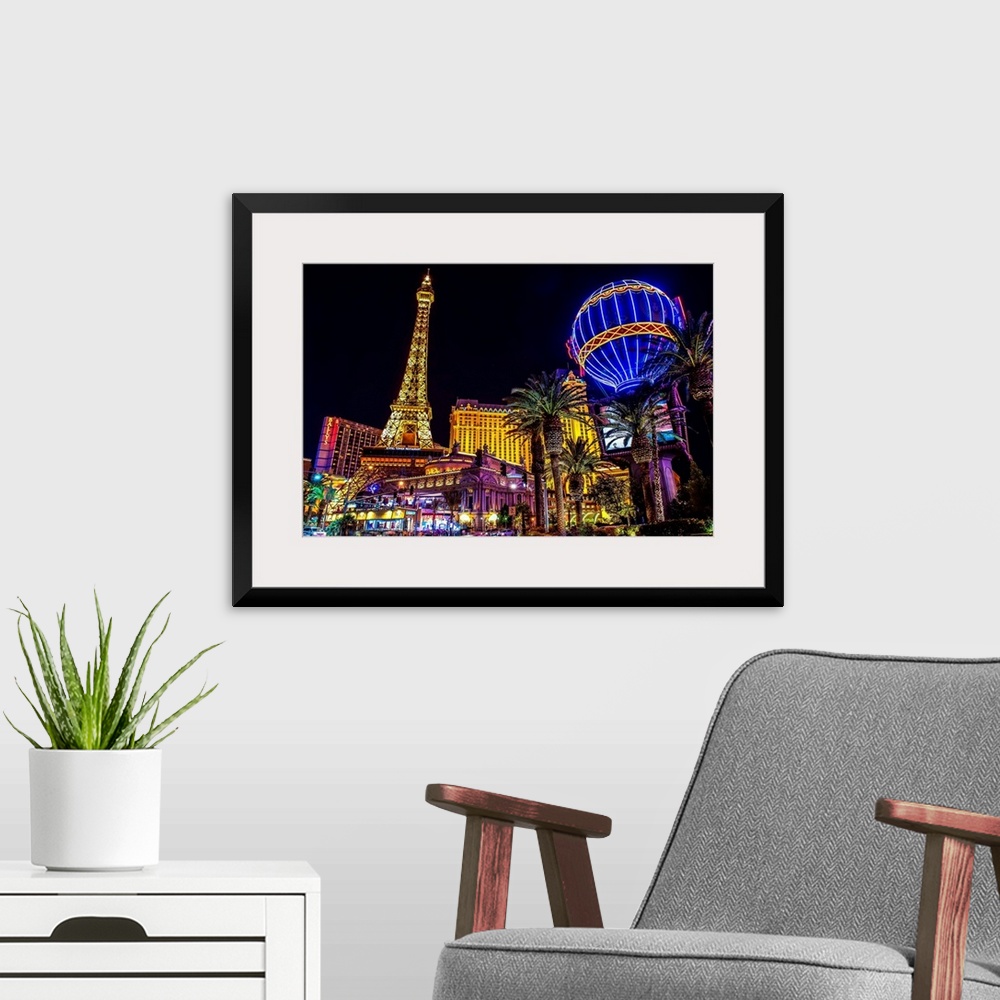 A modern room featuring Evening photograph of the Las Vegas strip with the Eiffel Tower and hot air balloon.