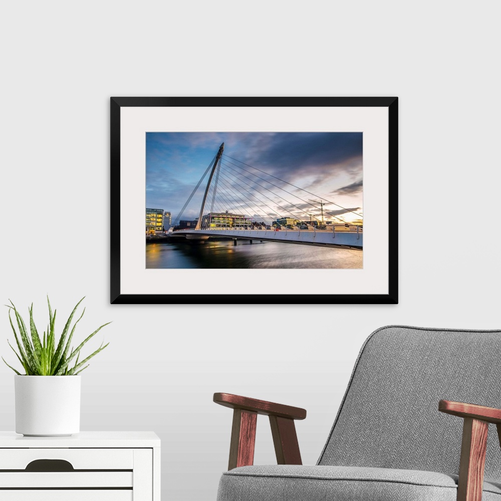 A modern room featuring Photograph of the Samuel Beckett Bridge, a cable-stayed bridge in Dublin, Ireland going across th...
