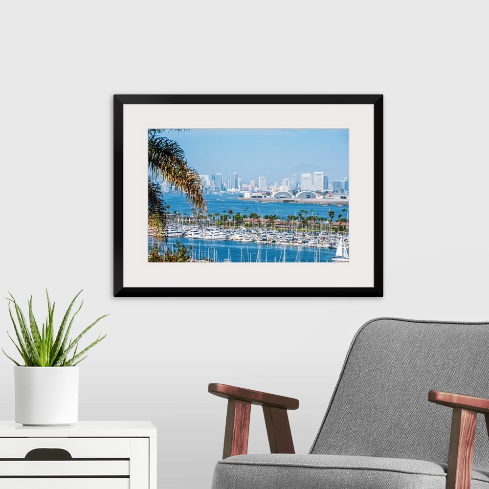 A modern room featuring Panoramic photograph of the San Diego, California skyline with a marina in the foreground packed ...