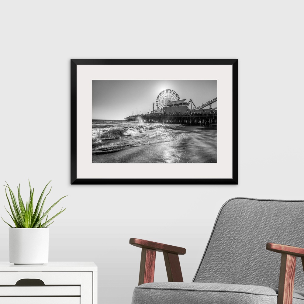 A modern room featuring Photograph of the Santa Monica Pier in Los Angeles, California, with the sun setting right behind...