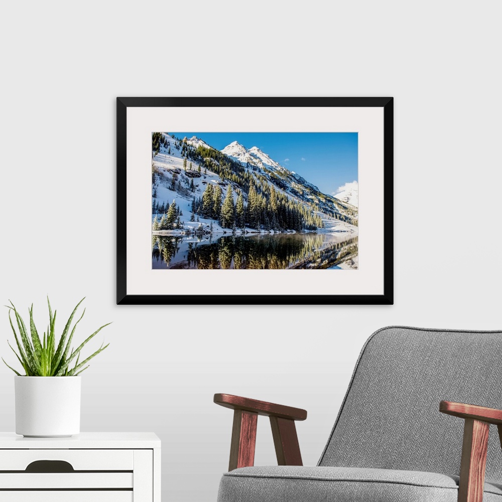A modern room featuring Summer snow on pine trees and the mountain side at the edge of Maroon Lake in the Maroon Bells, A...
