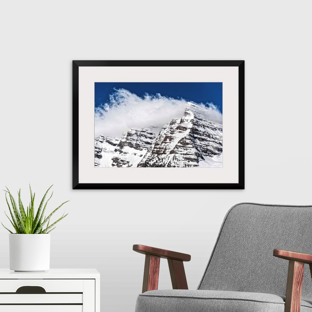 A modern room featuring Wind-blown snow on the peaks of the Maroon Bells under a blue sky in Aspen, Colorado.