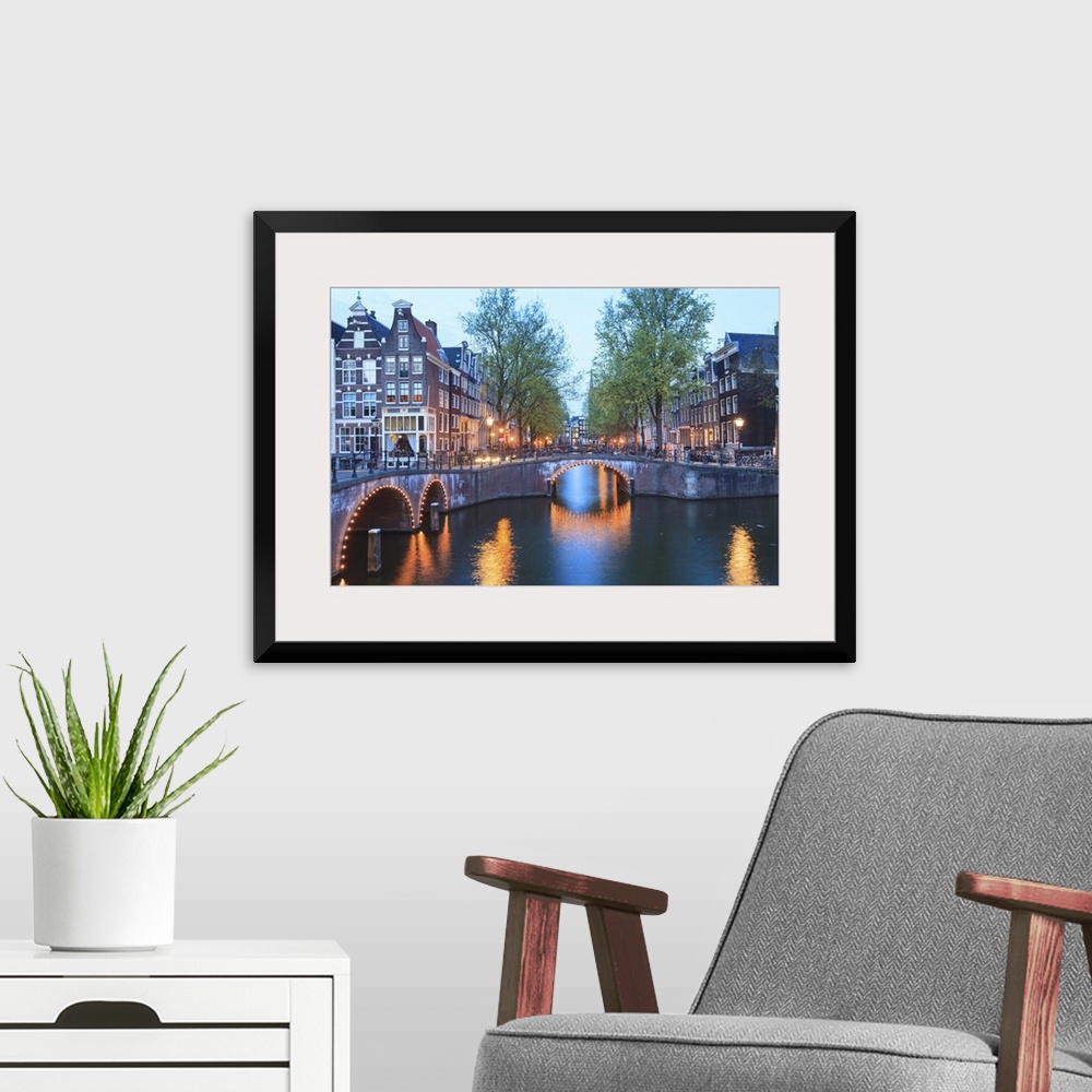 A modern room featuring Keizersgracht and Leidsegracht canals at dusk, Amsterdam, Netherlands, Europe.