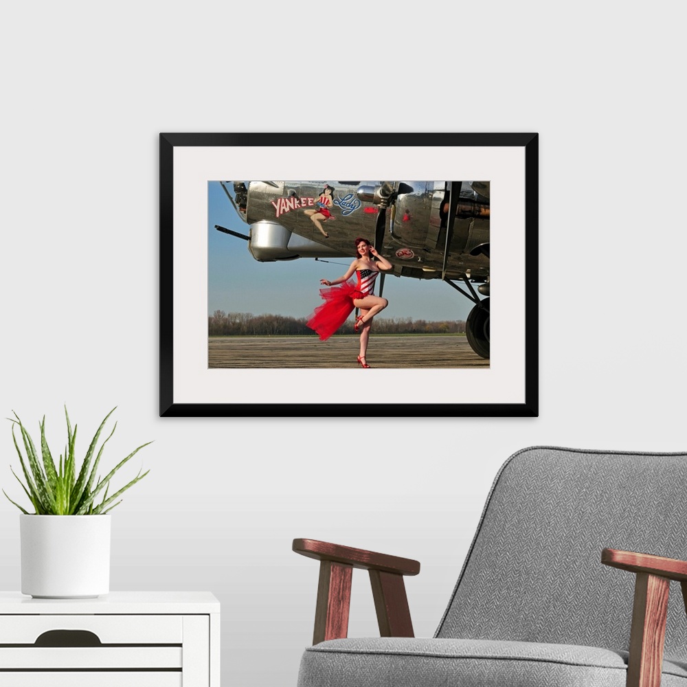A modern room featuring Beautiful 1940's style pin-up girl standing in front of a B-17 bomber.