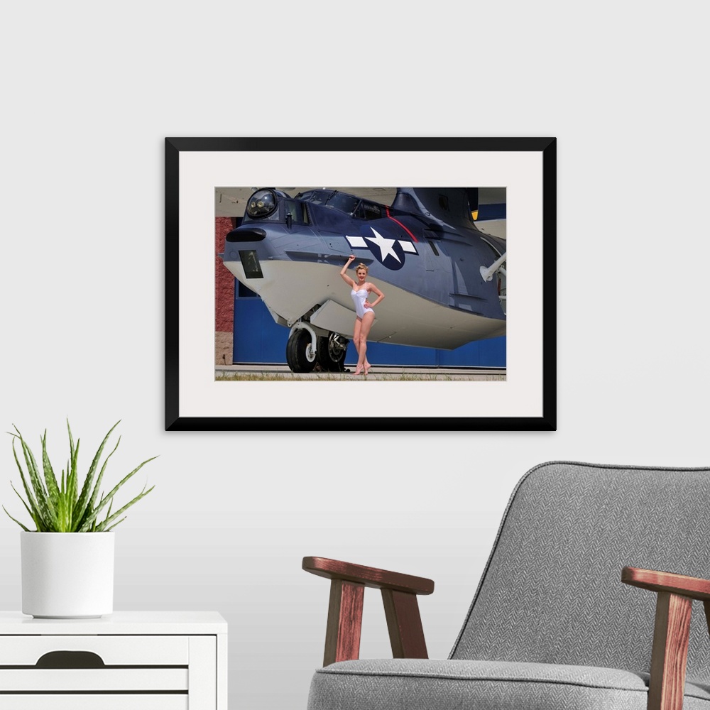 A modern room featuring Retro pin-up girl posing with a World War II era PBY Catalina seaplane.