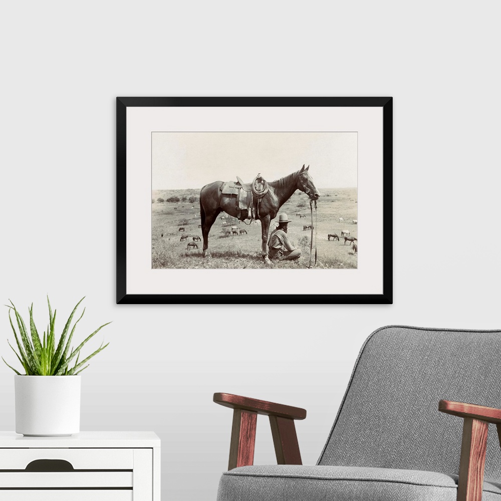 A modern room featuring Texas, Cowboy, C1910. A Horse Wrangler Seated Next To His Horse On A Hill And Looking Down At Oth...