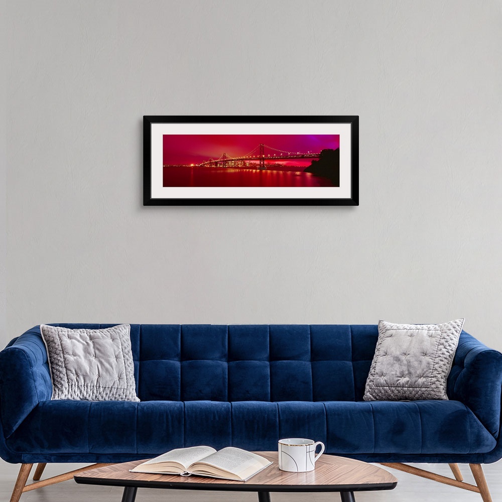 A modern room featuring This panoramic landscape photograph was taken at just time of day to turn the sky a brilliant hot...