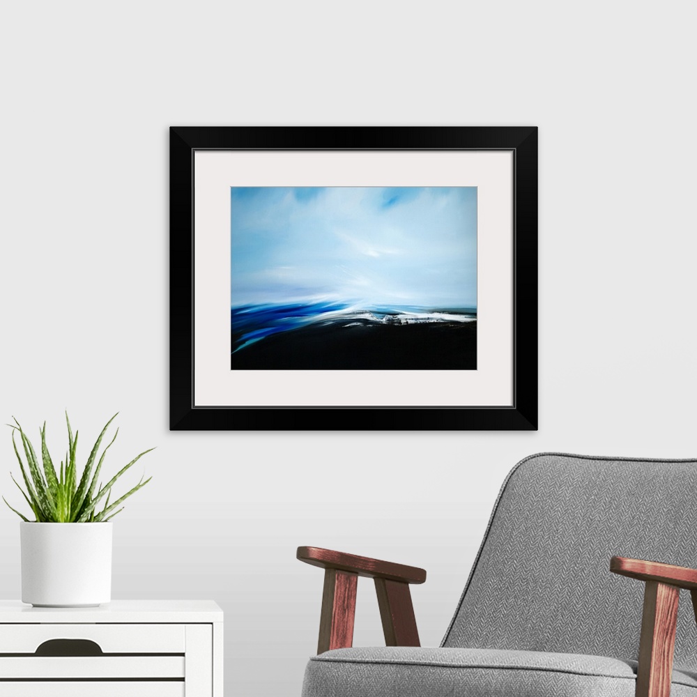 A modern room featuring A seascape with stark contrast between the dark see and light sky.