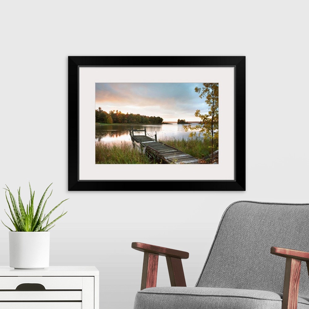 A modern room featuring A Dock On A Lake At Sunrise Near Wawa; Ontario, Canada