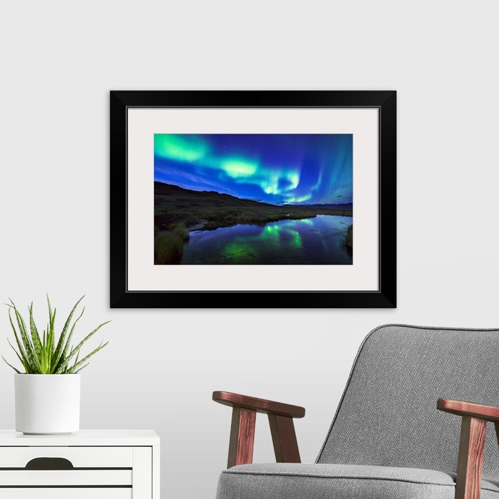 A modern room featuring Aurora borealis over a pond in Denali National Park and Preserve, Alaska.