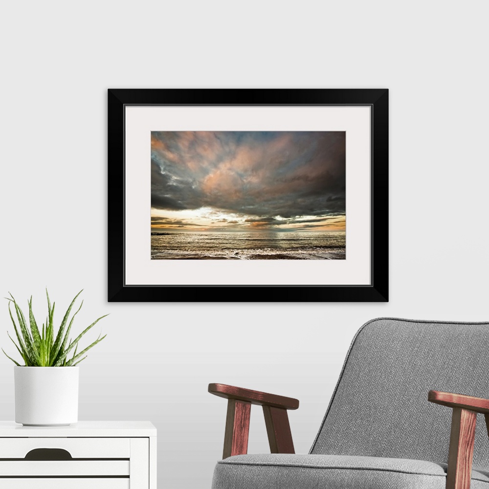 A modern room featuring Dramatic clouds at sunset over the water. South Shields, Tyne and Wear, England.