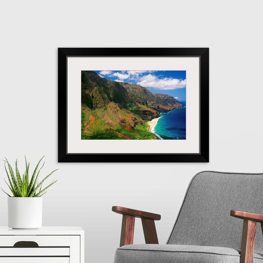 A modern room featuring Immense cliffs that line the Hawaiian coast are photographed on a bright sunny day.
