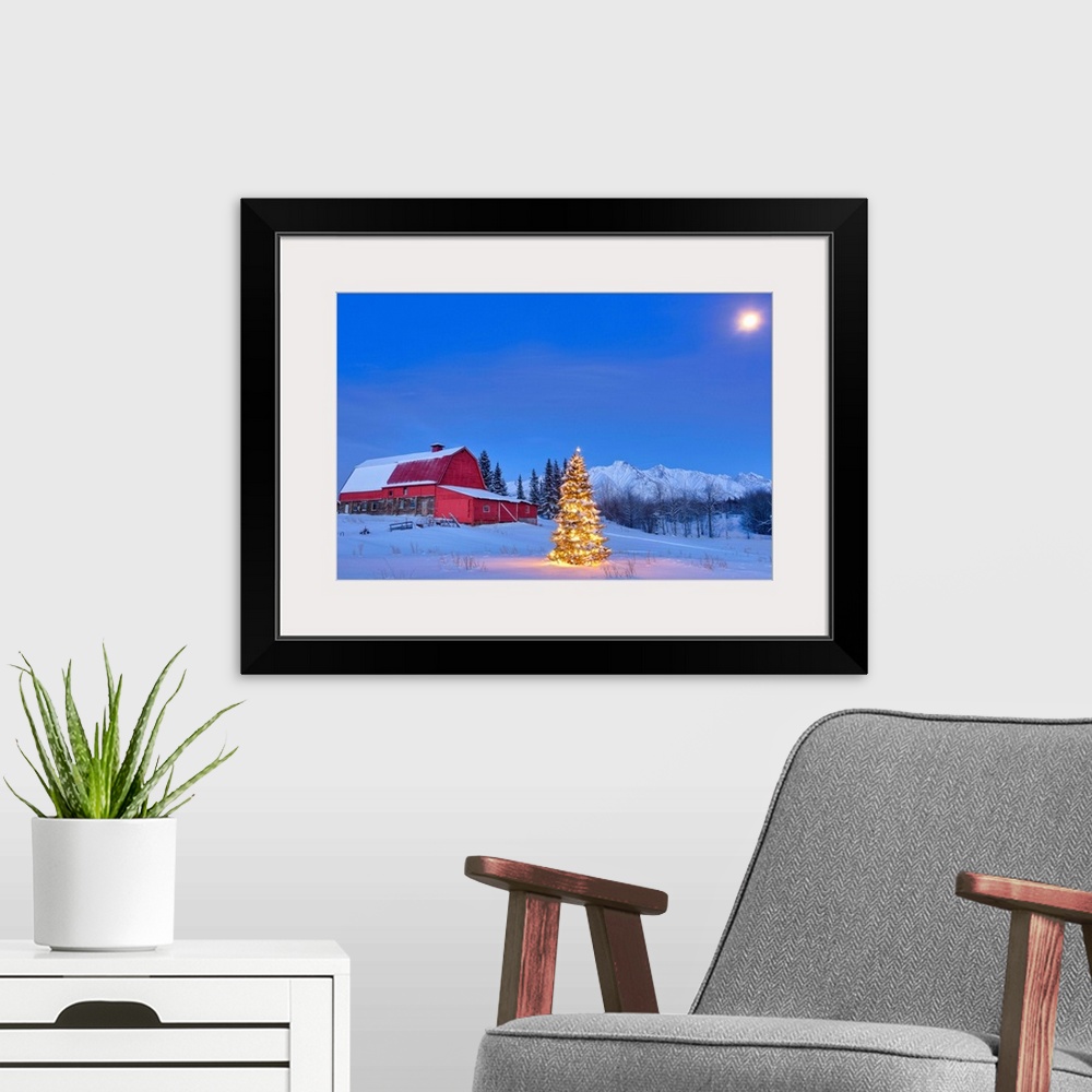 A modern room featuring Lit christmas tree in a snow covered field standing in front of a red barn