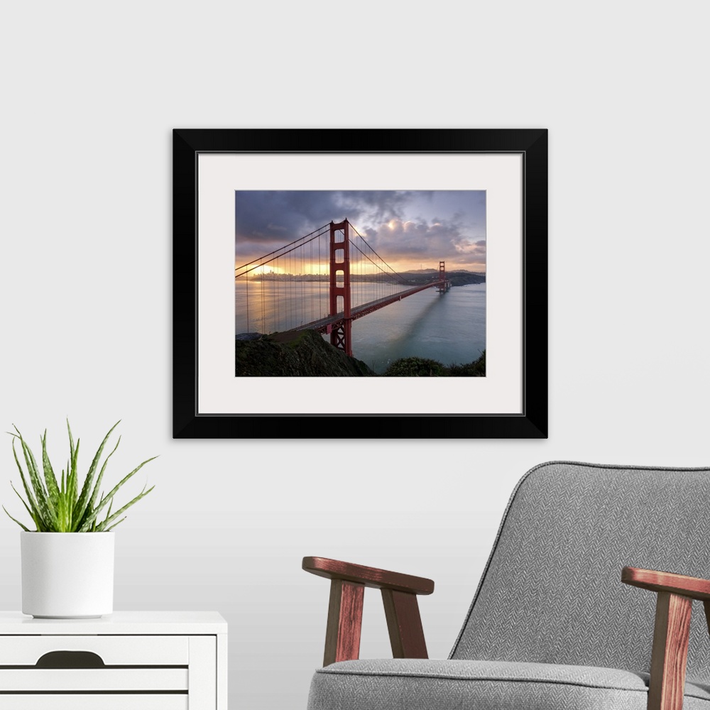 A modern room featuring The Golden Gate Bridge in San Francisco at sunrise.