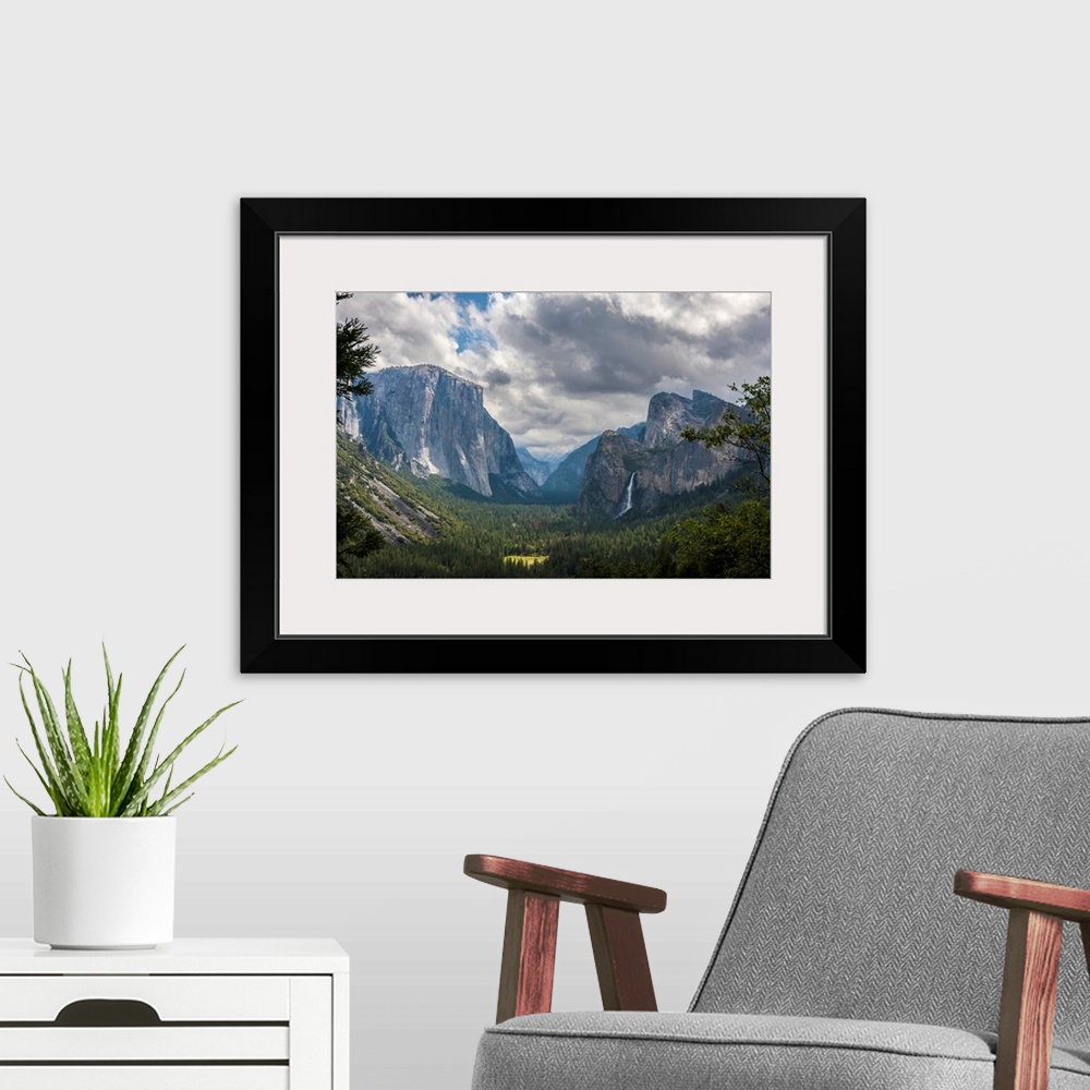 A modern room featuring Clouds move over Yosemite Valley, with Bridalveil Falls on the right and El Capitan on the left, ...