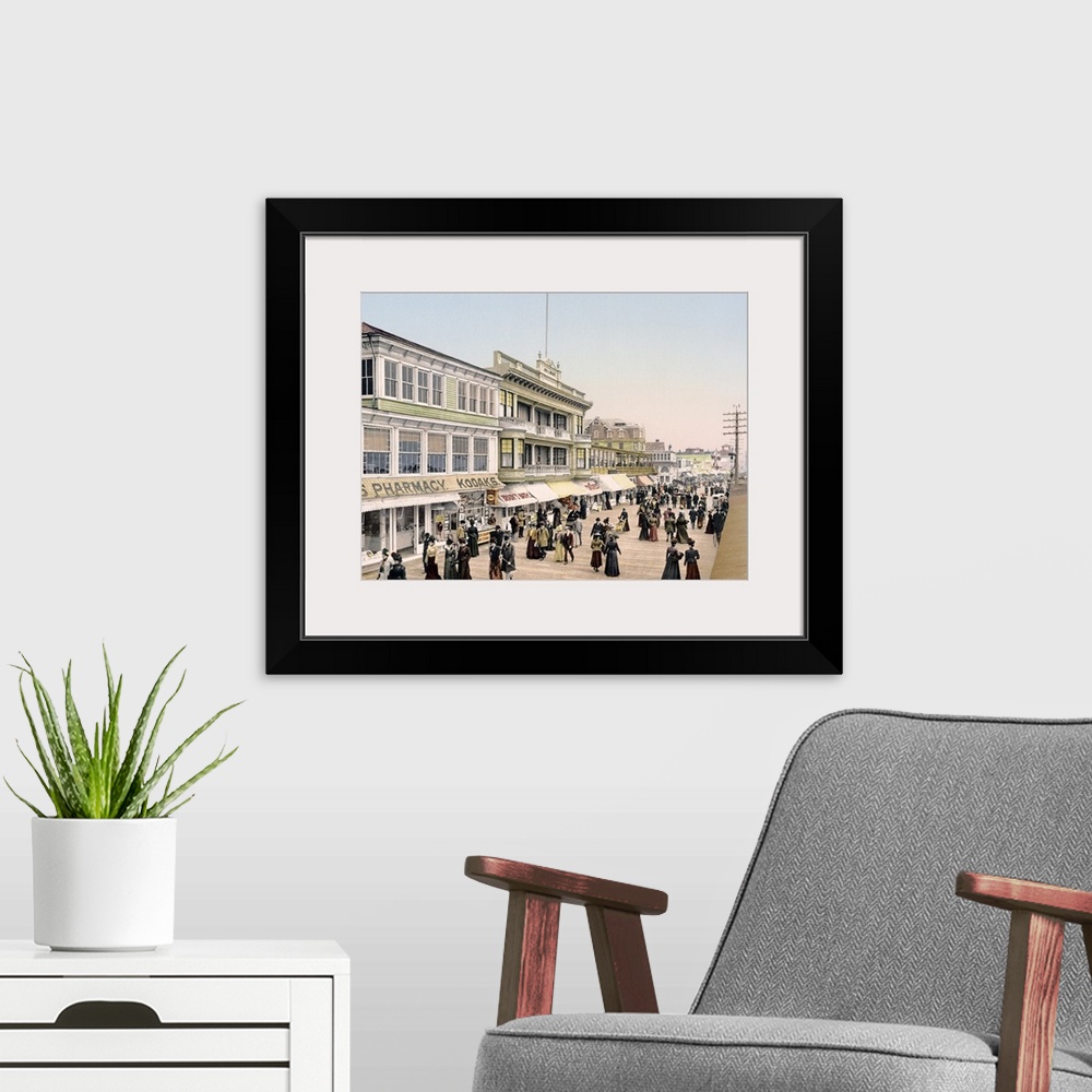 A modern room featuring Antique poster of the Atlantic City boardwalk in New Jersey. Shops line the left side with hundre...