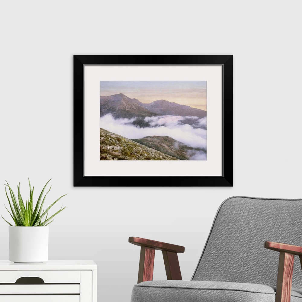 A modern room featuring Photograph of mountains peeking through fog.
