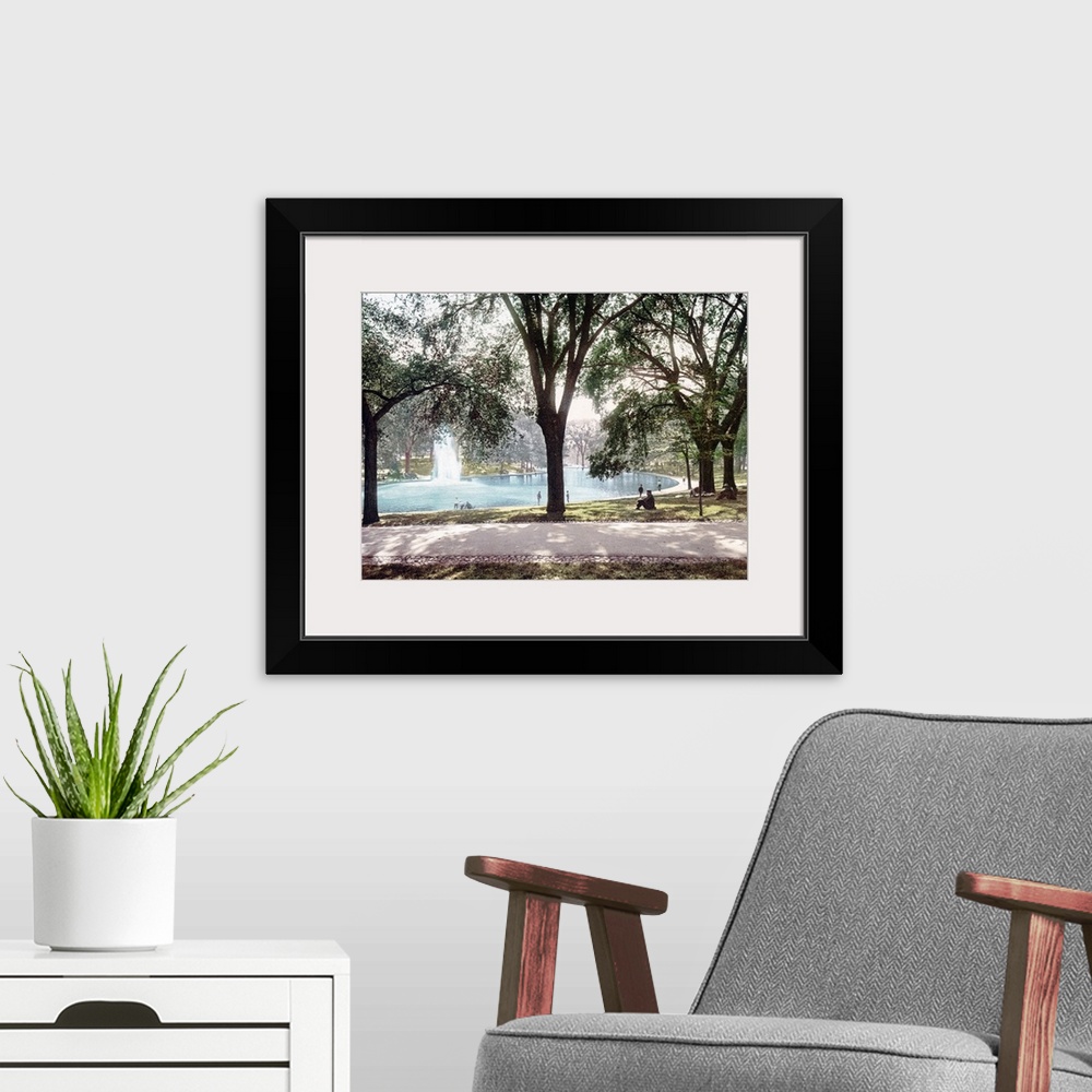 A modern room featuring Vintage colored photograph of a pond in Boston Common Park with a spouting water feature in the m...