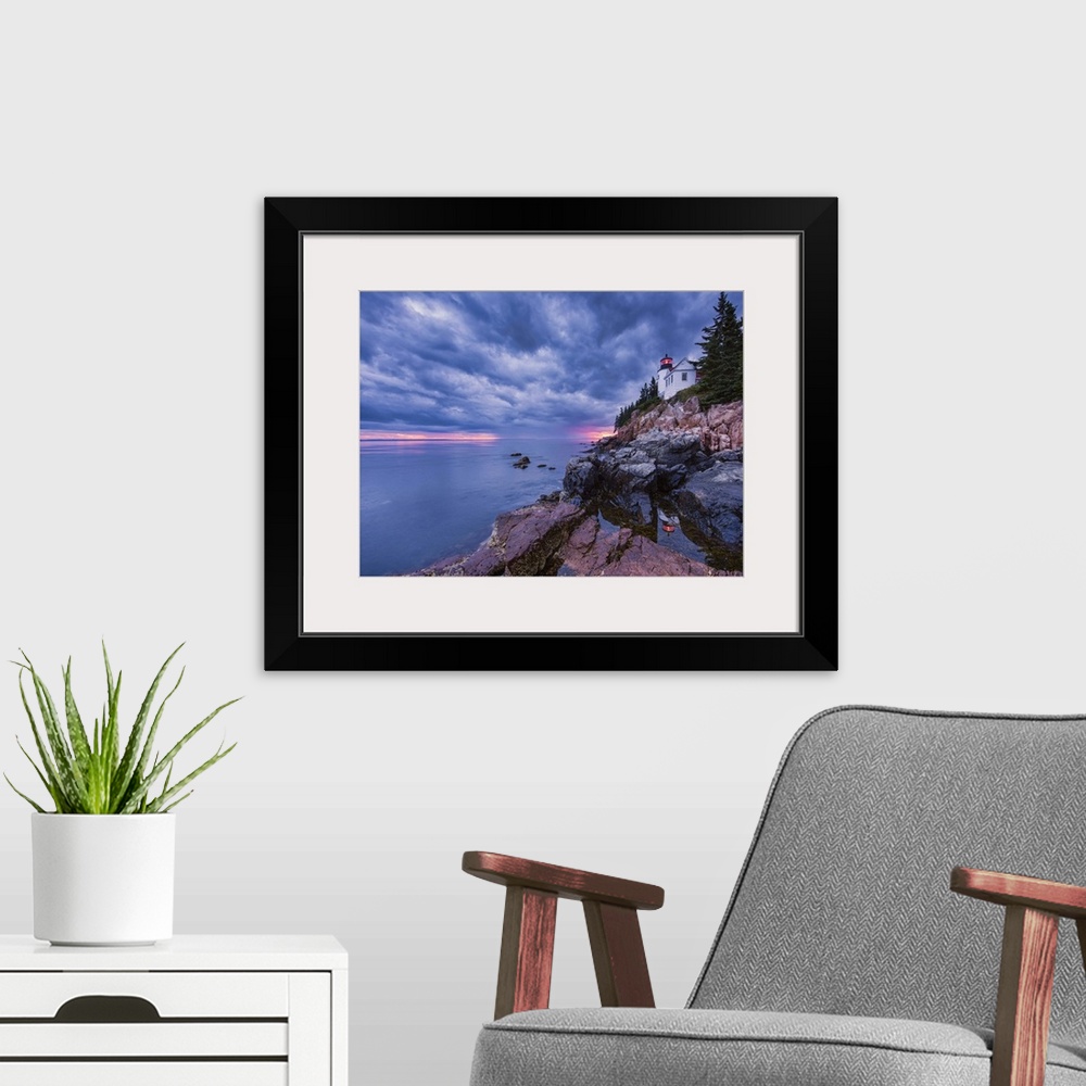 A modern room featuring Photograph of a white lighthouse on the coast of Maine, with the sun setting under big textured  ...